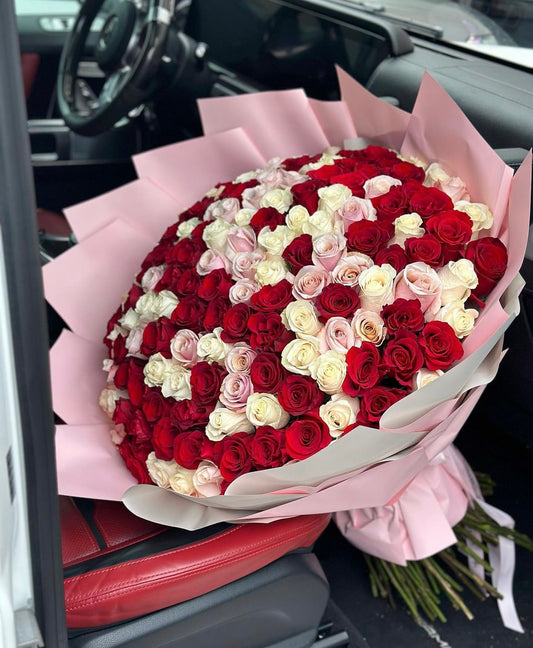 mix of red white and pink roses in a bouquet