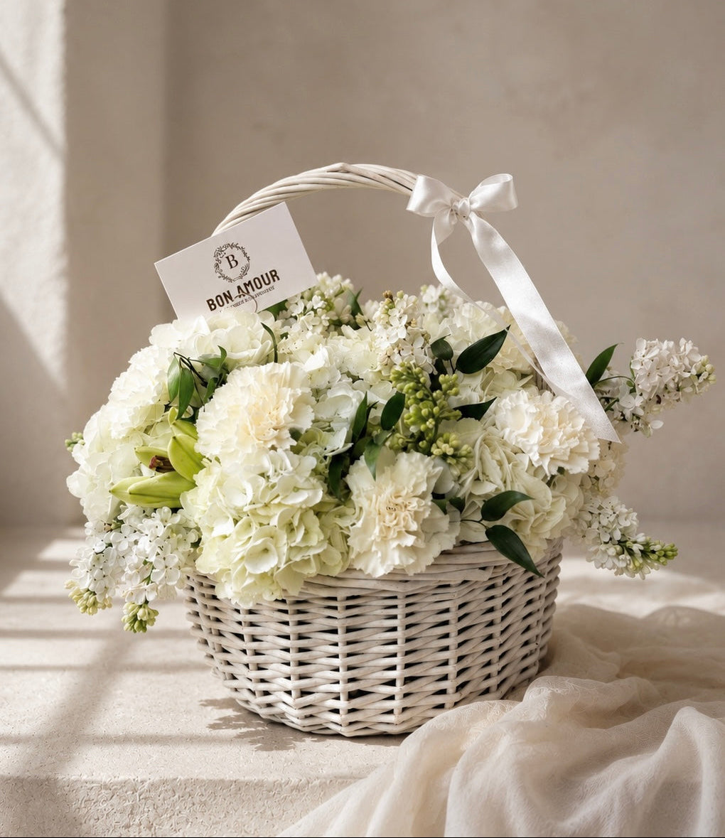 White flower basket with a 'Bon Amour' tag on a light background