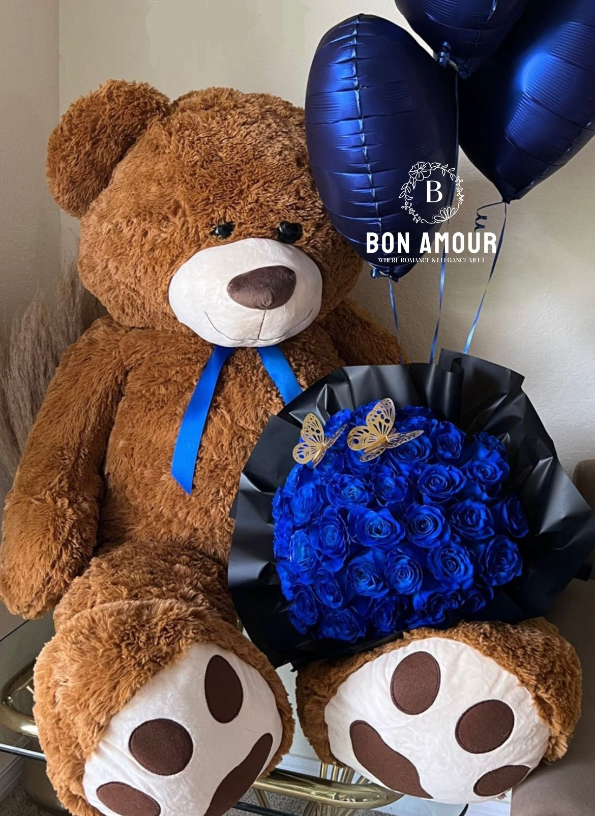 picture of brown teddy with blue flowers