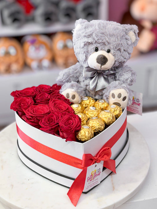 Half red roses and Ferrero chocolates with a teddy in a heart box