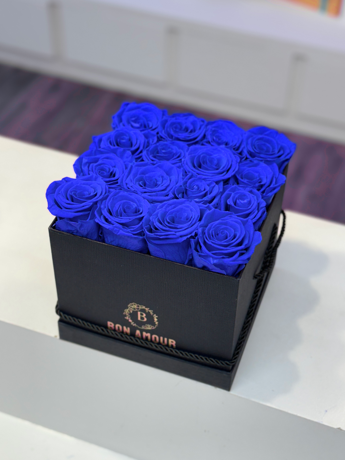 Blue preserved roses in a black square case